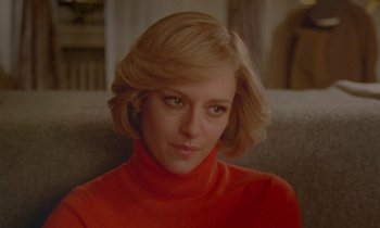 Movie still from “Spencer” (2021), directed by Pablo Larraín – A person sitting on a couch wearing a sweater; Close Up shot, Over the shoulder angle