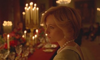 Movie still from “Spencer” (2021), directed by Pablo Larraín – A woman sitting in front of a table with lit candles; Close Up shot, Over the shoulder angle