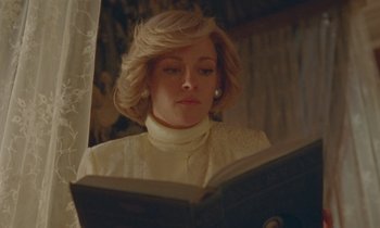 Movie still from “Spencer” (2021), directed by Pablo Larraín – A woman reading a book while sitting in a chair; Close Up shot, Low angle