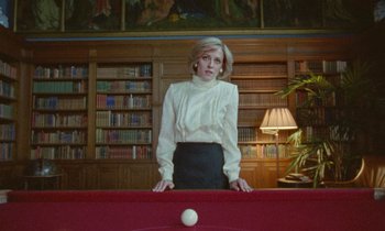 Movie still from “Spencer” (2021), directed by Pablo Larraín – A woman standing on top of a pool table; Medium shot, Low angle
