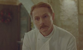 Movie still from “Spencer” (2021), directed by Pablo Larraín – A person wearing a chef's outfit; Close Up shot, Low angle