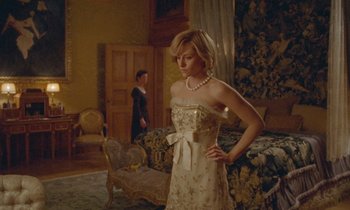 Movie still from “Spencer” (2021), directed by Pablo Larraín – A woman in a white dress standing next to a man in a suit; Medium shot, Low angle