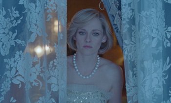 Movie still from “Spencer” (2021), directed by Pablo Larraín – A woman wearing a white dress and a pearl necklace; Close Up shot, Low angle