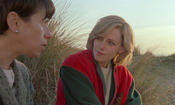 Movie still from “Spencer” (2021), directed by Pablo Larraín – A woman and a boy are sitting in the grass; Close Up shot, Over the shoulder angle