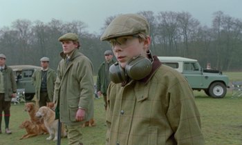 Movie still from “Spencer” (2021), directed by Pablo Larraín – A group of young men standing next to each other on top of a field; Medium shot, Low angle
