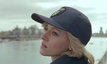 Movie still from “Spencer” (2021), directed by Pablo Larraín – A woman wearing a hat and looking to her left; Close Up shot, Low angle