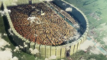 Movie still from “Attack on Titan” (2013), directed by Masashi Koizuka – An aerial view of a large city with a lot of buildings in it; Extreme Wide shot, Overhead angle