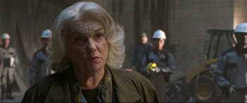 Movie still from “Spider-Man: Homecoming” (2017), directed by Jon Watts – An older woman in a green jacket and a man in a hard hat; Close Up shot, Over the shoulder angle