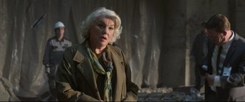 Movie still from “Spider-Man: Homecoming” (2017), directed by Jon Watts – An older woman with white hair wearing a brown jacket; Close Up shot, Low angle