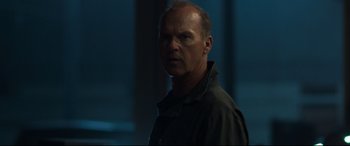 Movie still from “Spider-Man: Homecoming” (2017), directed by Jon Watts – A man with a goatee standing next to a window; Close Up shot, Low angle