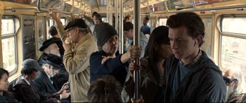 Movie still from “Spider-Man: Homecoming” (2017), directed by Jon Watts – A group of people riding on a train; Medium shot, Over the shoulder angle