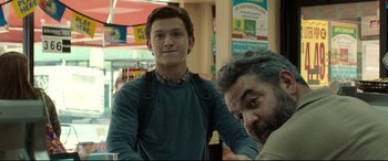 Movie still from “Spider-Man: Homecoming” (2017), directed by Jon Watts – A man standing next to another man in a store; Close Up shot, Over the shoulder angle