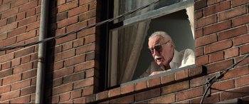 Movie still from “Spider-Man: Homecoming” (2017), directed by Jon Watts – An older man looking out of a window; Medium shot, Over the shoulder angle