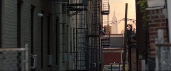 Movie still from “Spider-Man: Homecoming” (2017), directed by Jon Watts – A spider - man climbing up the side of a tall building; Extreme Wide shot, Low angle