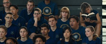 Movie still from “Spider-Man: Homecoming” (2017), directed by Jon Watts – A group of young people wearing blue shirts and glasses; Medium shot, Over the shoulder angle