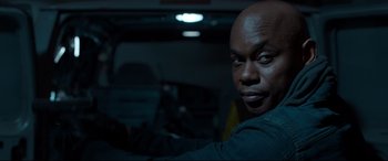 Movie still from “Spider-Man: Homecoming” (2017), directed by Jon Watts – A man sitting in the driver's seat of a car; Close Up shot, Over the shoulder angle