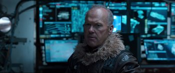 Movie still from “Spider-Man: Homecoming” (2017), directed by Jon Watts – A man with a fur collar in front of a monitor; Close Up shot, Over the shoulder angle