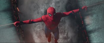 Movie still from “Spider-Man: Homecoming” (2017), directed by Jon Watts – A spider - man flying through the air with his arms outstretched; Medium shot, Overhead angle