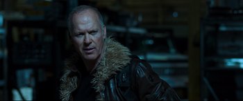 Movie still from “Spider-Man: Homecoming” (2017), directed by Jon Watts – A man in a leather jacket with a fur collar; Close Up shot, Over the shoulder angle