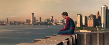 Movie still from “Spider-Man: Homecoming” (2017), directed by Jon Watts – A man sitting on the edge of a pier looking out at the water; Medium shot, High angle