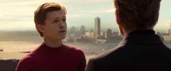 Movie still from “Spider-Man: Homecoming” (2017), directed by Jon Watts – A man and a woman are talking in front of a city; Close Up shot, Over the shoulder angle