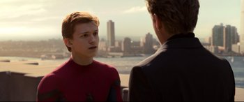 Movie still from “Spider-Man: Homecoming” (2017), directed by Jon Watts – A man in a suit talking to another man in a suit; Close Up shot, Over the shoulder angle