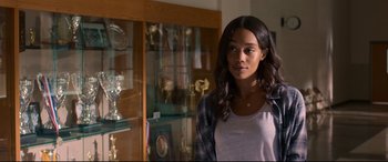 Movie still from “Spider-Man: Homecoming” (2017), directed by Jon Watts – A woman standing in front of a display case; Close Up shot, Over the shoulder angle