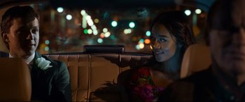 Movie still from “Spider-Man: Homecoming” (2017), directed by Jon Watts – A woman sitting in the back seat of a car at night; Close Up shot, Over the shoulder angle