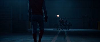 Movie still from “Spider-Man: Homecoming” (2017), directed by Jon Watts – A man sitting on a bench next to another man; Wide shot, Over the shoulder angle