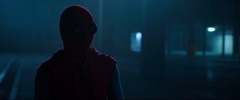 Movie still from “Spider-Man: Homecoming” (2017), directed by Jon Watts – A man in a spider - man costume standing in the dark; Close Up shot, Over the shoulder angle