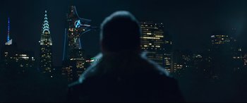 Movie still from “Spider-Man: Homecoming” (2017), directed by Jon Watts – A man standing in front of a city skyline at night; Extreme Wide shot, Low angle