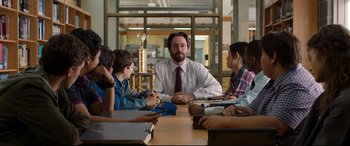 Movie still from “Spider-Man: Homecoming” (2017), directed by Jon Watts – A group of people sitting around a table; Medium shot, Over the shoulder angle