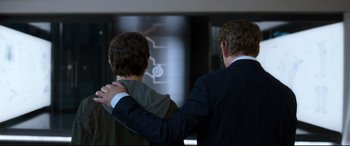 Movie still from “Spider-Man: Homecoming” (2017), directed by Jon Watts – Two men in suits holding each other's hands; Medium shot, Over the shoulder angle