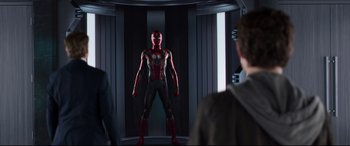 Movie still from “Spider-Man: Homecoming” (2017), directed by Jon Watts – A man standing in front of another man in front of a mirror; Medium shot, Over the shoulder angle