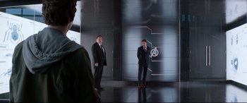 Movie still from “Spider-Man: Homecoming” (2017), directed by Jon Watts – Two men in suits standing in front of a mirror; Wide shot, Over the shoulder angle