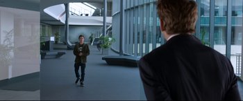 Movie still from “Spider-Man: Homecoming” (2017), directed by Jon Watts – A man standing in front of another man holding a camera; Wide shot, Over the shoulder angle