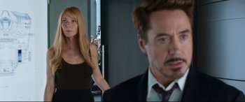 Movie still from “Spider-Man: Homecoming” (2017), directed by Jon Watts – A man and a woman standing next to each other in a room; Medium shot, Over the shoulder angle