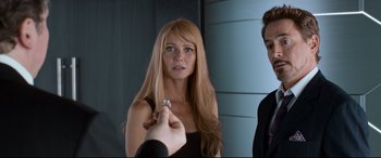Movie still from “Spider-Man: Homecoming” (2017), directed by Jon Watts – A woman in front of a mirror holding a ring in her hand; Close Up shot, Over the shoulder angle