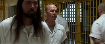 Movie still from “Spider-Man: Homecoming” (2017), directed by Jon Watts – A man standing in front of a jail cell; Close Up shot, Over the shoulder angle