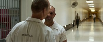 Movie still from “Spider-Man: Homecoming” (2017), directed by Jon Watts – A man in white shirt looking in the mirror; Medium shot, Over the shoulder angle