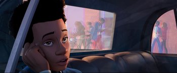 Movie still from “Spider-Man: Into the Spider-Verse” (2018), directed by Peter Ramsey – A man sitting in front of a window looking at a screen; Close Up shot, Over the shoulder angle