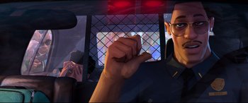 Movie still from “Spider-Man: Into the Spider-Verse” (2018), directed by Peter Ramsey – A man holding his fist up in the air in front of a window; Close Up shot, Low angle