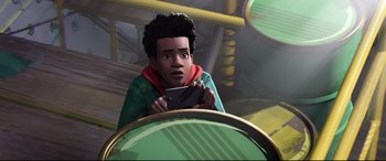 Movie still from “Spider-Man: Into the Spider-Verse” (2018), directed by Peter Ramsey – A boy holding a cell phone in his hands; Medium shot, Over the shoulder angle