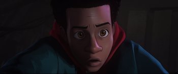 Movie still from “Spider-Man: Into the Spider-Verse” (2018), directed by Peter Ramsey – An animation of a young man looking surprised at the camera; Close Up shot, Low angle