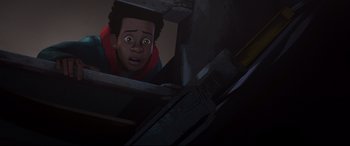 Movie still from “Spider-Man: Into the Spider-Verse” (2018), directed by Peter Ramsey – A young man is looking up at the ceiling; Medium shot, Overhead angle