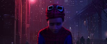 Movie still from “Spider-Man: Into the Spider-Verse” (2018), directed by Peter Ramsey – A man in a spider - man costume sitting in front of a building; Close Up shot, Over the shoulder angle