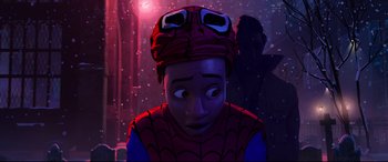 Movie still from “Spider-Man: Into the Spider-Verse” (2018), directed by Peter Ramsey – A man in a spider - man costume is looking at the camera; Close Up shot, Over the shoulder angle