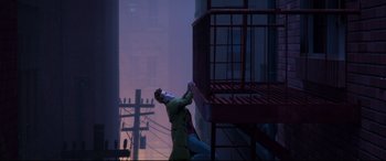 Movie still from “Spider-Man: Into the Spider-Verse” (2018), directed by Peter Ramsey – A man in a yellow jacket leaning on a fire escape; Wide shot, Overhead angle