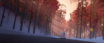 Movie still from “Spider-Man: Into the Spider-Verse” (2018), directed by Peter Ramsey – A bus driving down a road near a forest; Extreme Wide shot, Low angle
