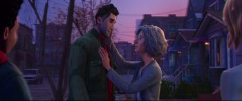 Movie still from “Spider-Man: Into the Spider-Verse” (2018), directed by Peter Ramsey – An animated man and a woman standing next to each other in front of a building; Medium shot, Over the shoulder angle